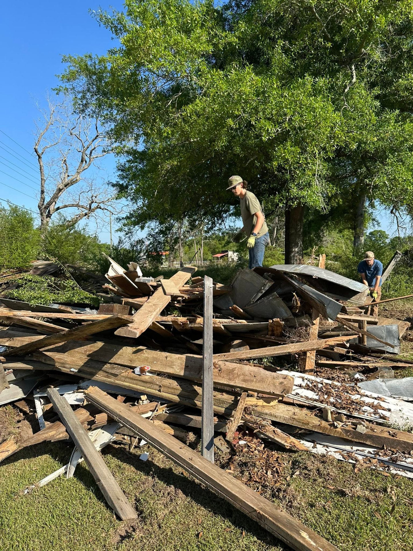 Crew stacking demolition debris and lumber